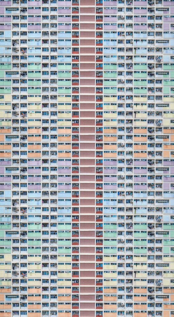 A colorful, modern residential building exterior in Hong Kong, emphasizing urban architecture.